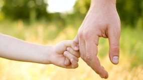 Child holding dad's hand